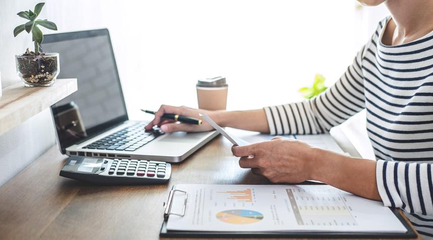 Woman with a laptop and calculator